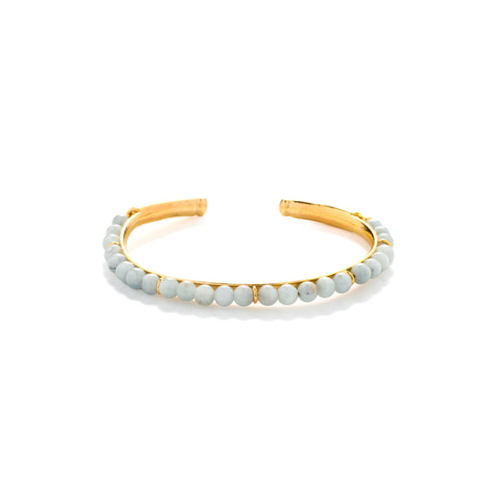 Aquamarine Bead Cuff Gold bracelet with light blue beads on a white background
