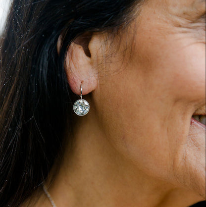 Close-up of a woman wearing sterling silver Sterling Silver Swarovski Crystal Earrings with a blurred background