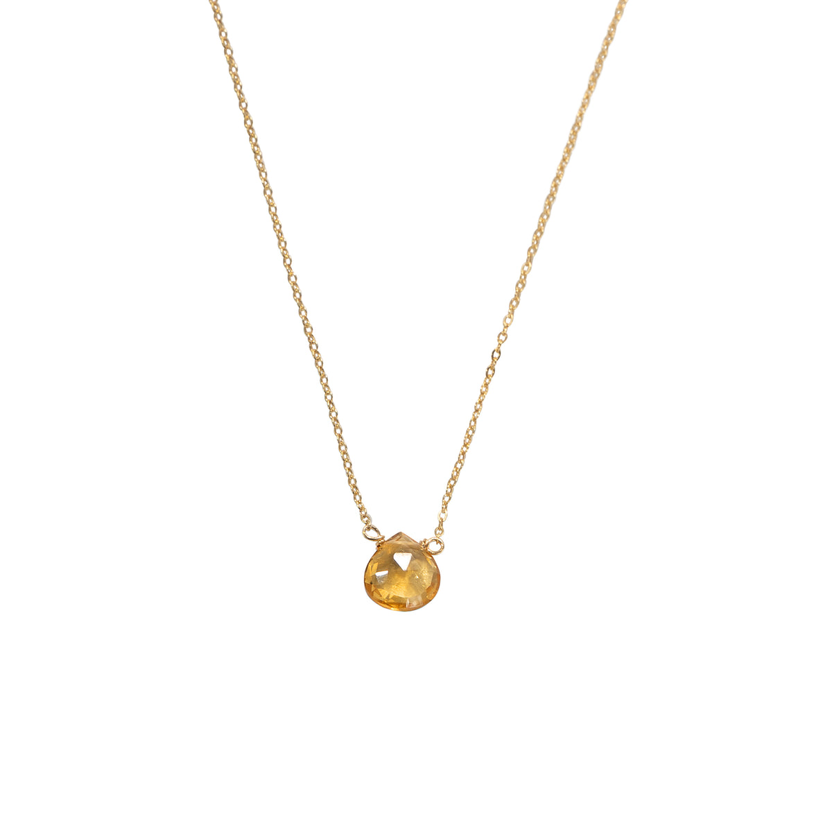 Gold triangle pendant necklace on a white background