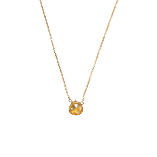 Gold triangle pendant necklace on a white background