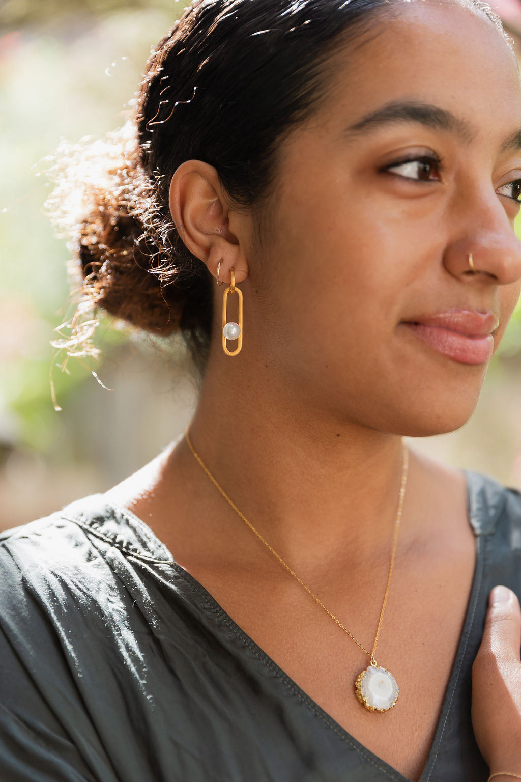 Close up of Pearl floating earrings and white agate slice necklace.jpg__PID:ee17cf85-2bf0-42d3-9719-c61627afcc3c
