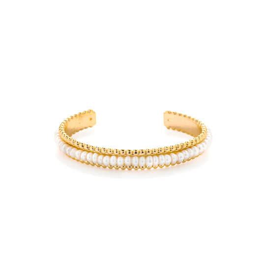 Gold bracelet with beaded pearl accents on a white background