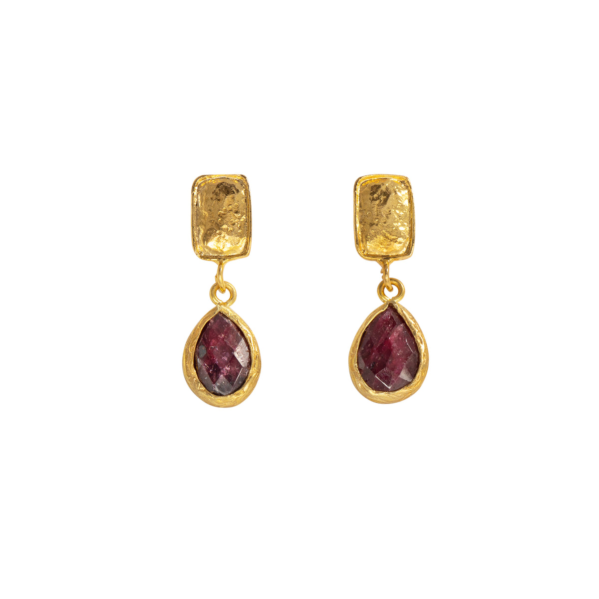 A pair of gold drop earrings featuring a textured rectangular gold top and a faceted teardrop-shaped deep red gemstone below, set against a plain white background.
